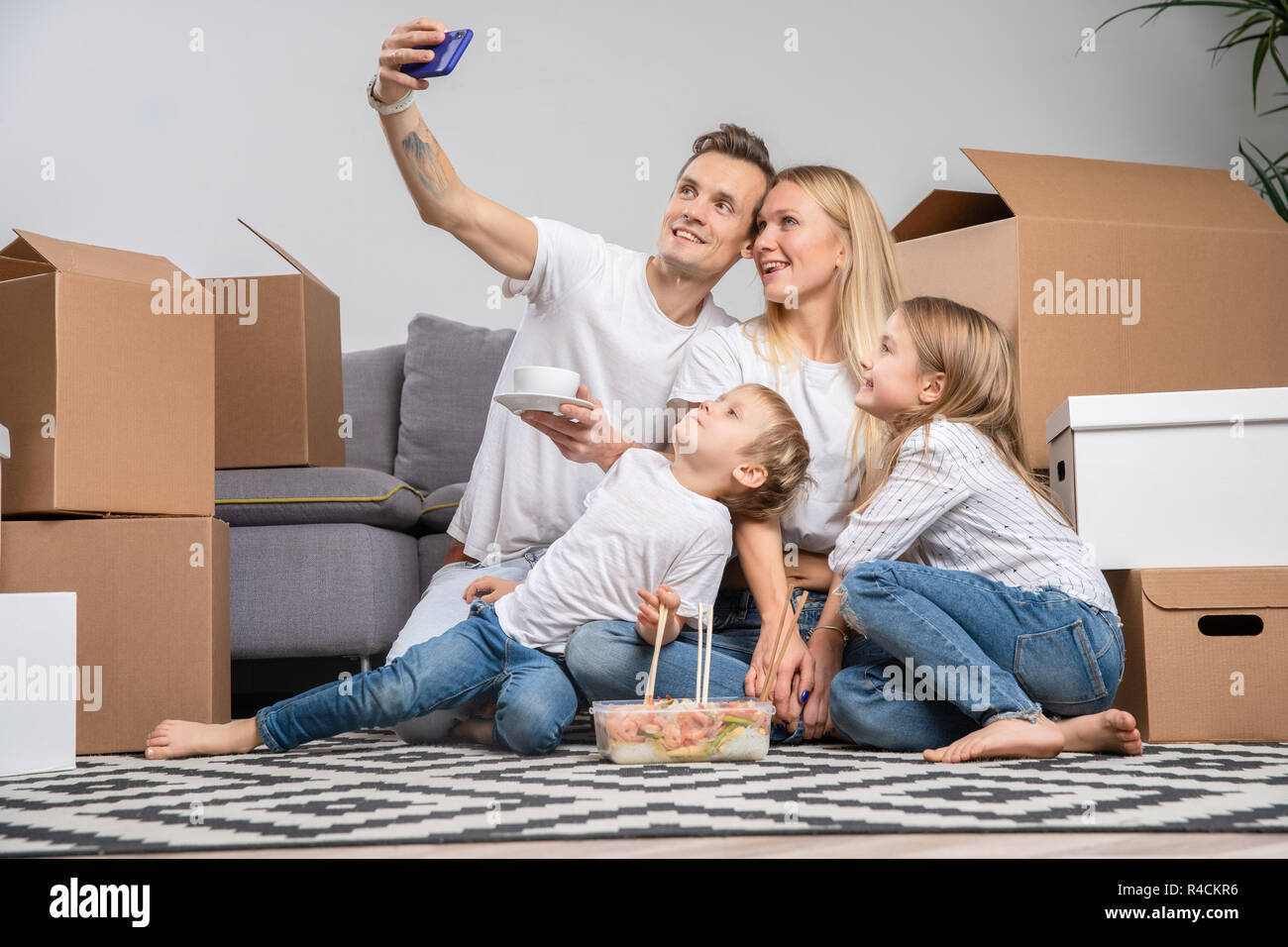 Photo of man, children and women taking pictures of yourself sitting on