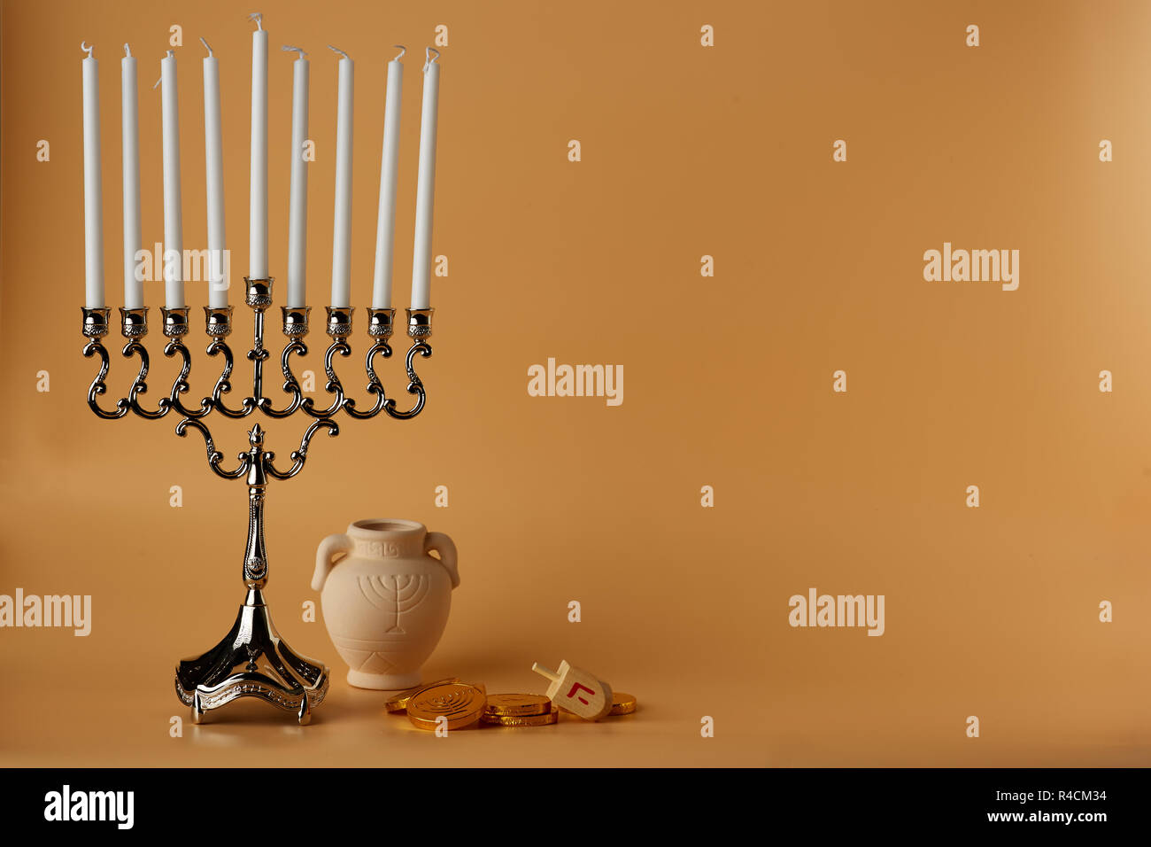 Menorah candlestick and pile of coins for holiday Stock Photo