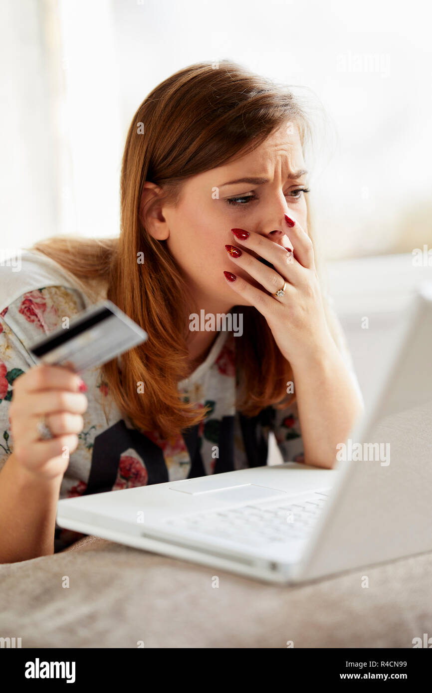 Girl overspent using her credit card Stock Photo