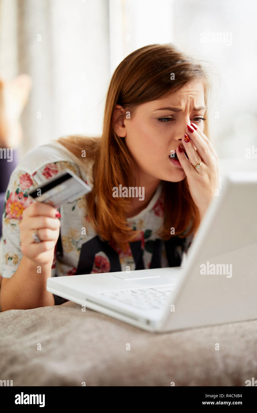 Girl overspent using her credit card Stock Photo