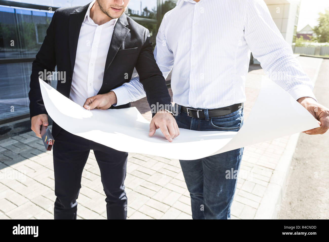 View of an Engineer and worker checking plan on construction site Stock ...