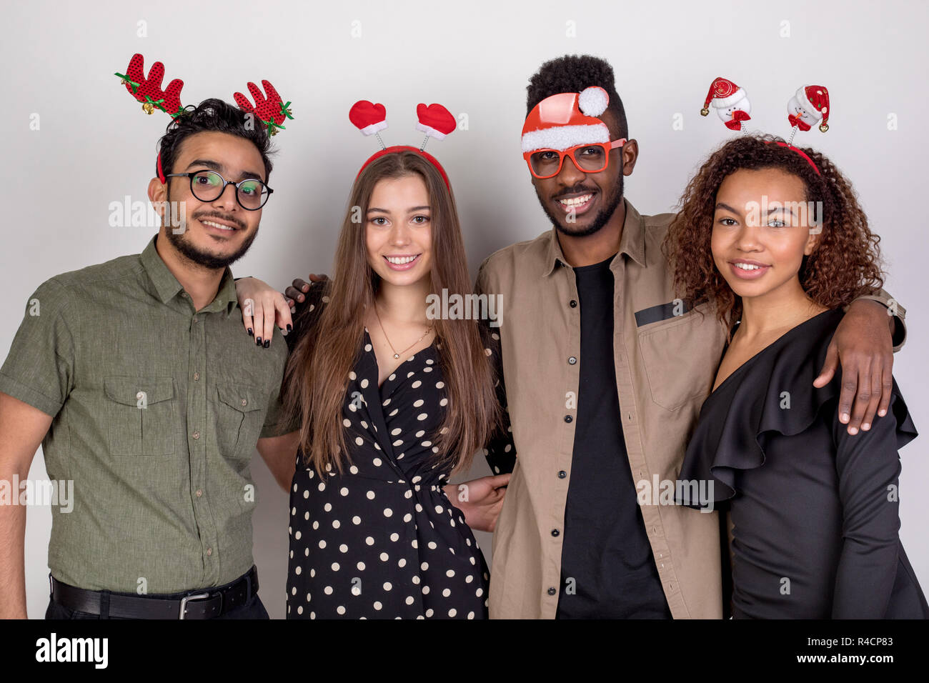 Four friends in funny New Year accessories. Stock Photo