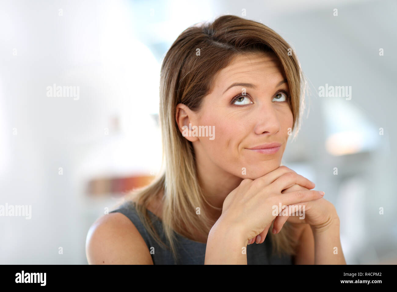 Portrait of businesswoman with thoughtful look Stock Photo - Alamy