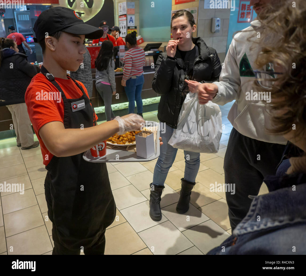 Shoppers grab Panda Express samples in the food court at the Queens