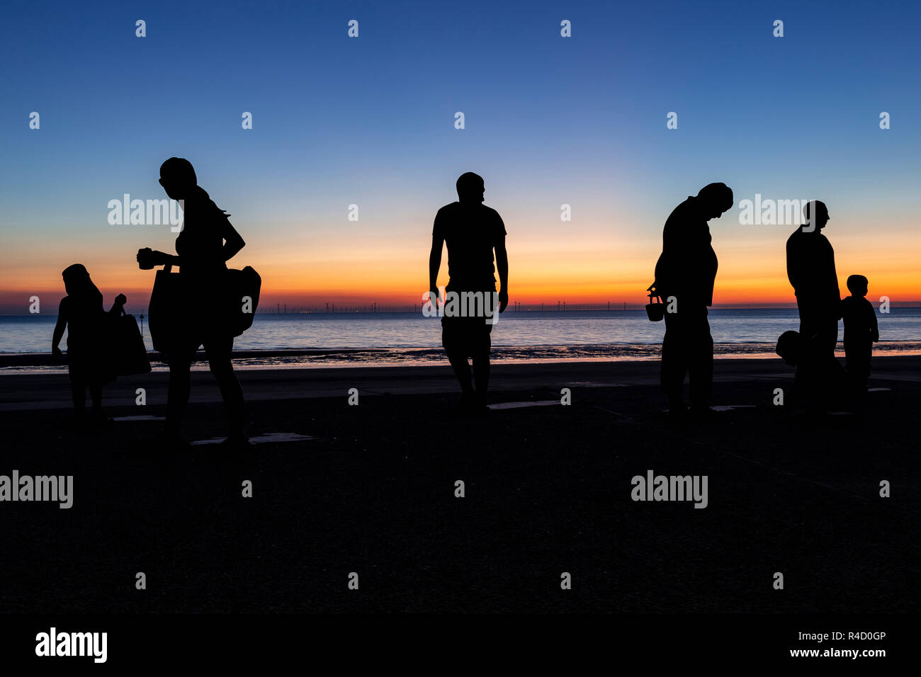 Sculptures of families on the seafront at Colwyn Bay at dawn, North Wales Stock Photo