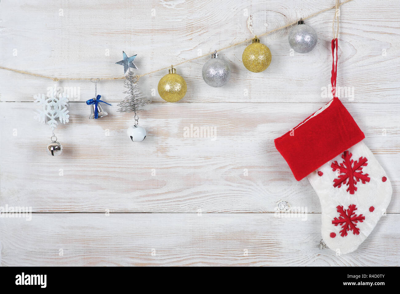 Christmas balls , sock and Christmas tree with a star hanging on a rope. white mottled background. Stock Photo