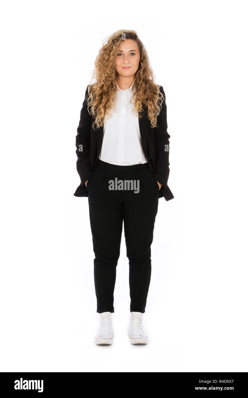 smiling girl with curly blonde hair she is standing with hands in pockets wearing a black suit and white shirt and sneakers R4D0X7