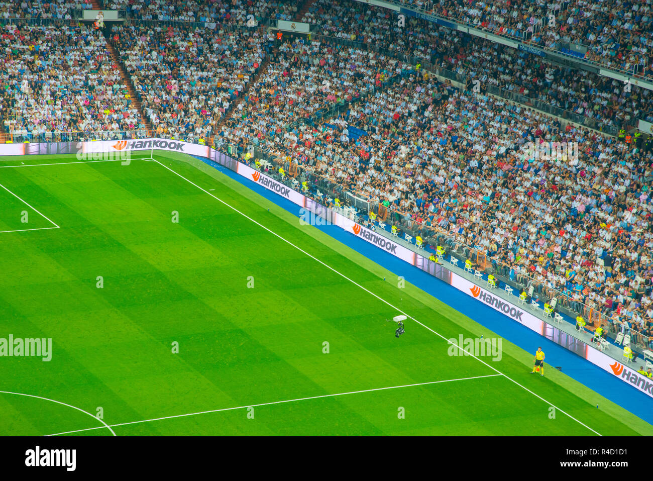 Linesman, spectators and camera in a football match. Santiago Bernabeu stadium, Madrid, Spain. Stock Photo