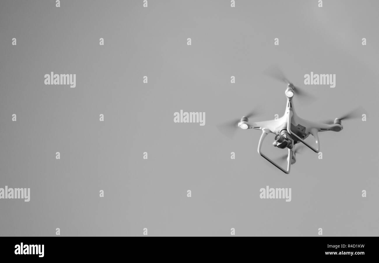 The drone, hovering in the sky. Flight quadrocopters Stock Photo