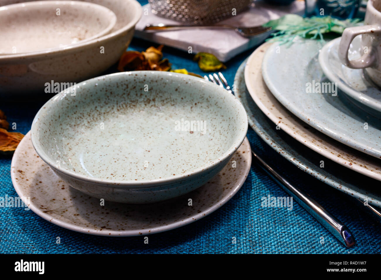 Table with dishes on a blue tablecloth Stock Photo
