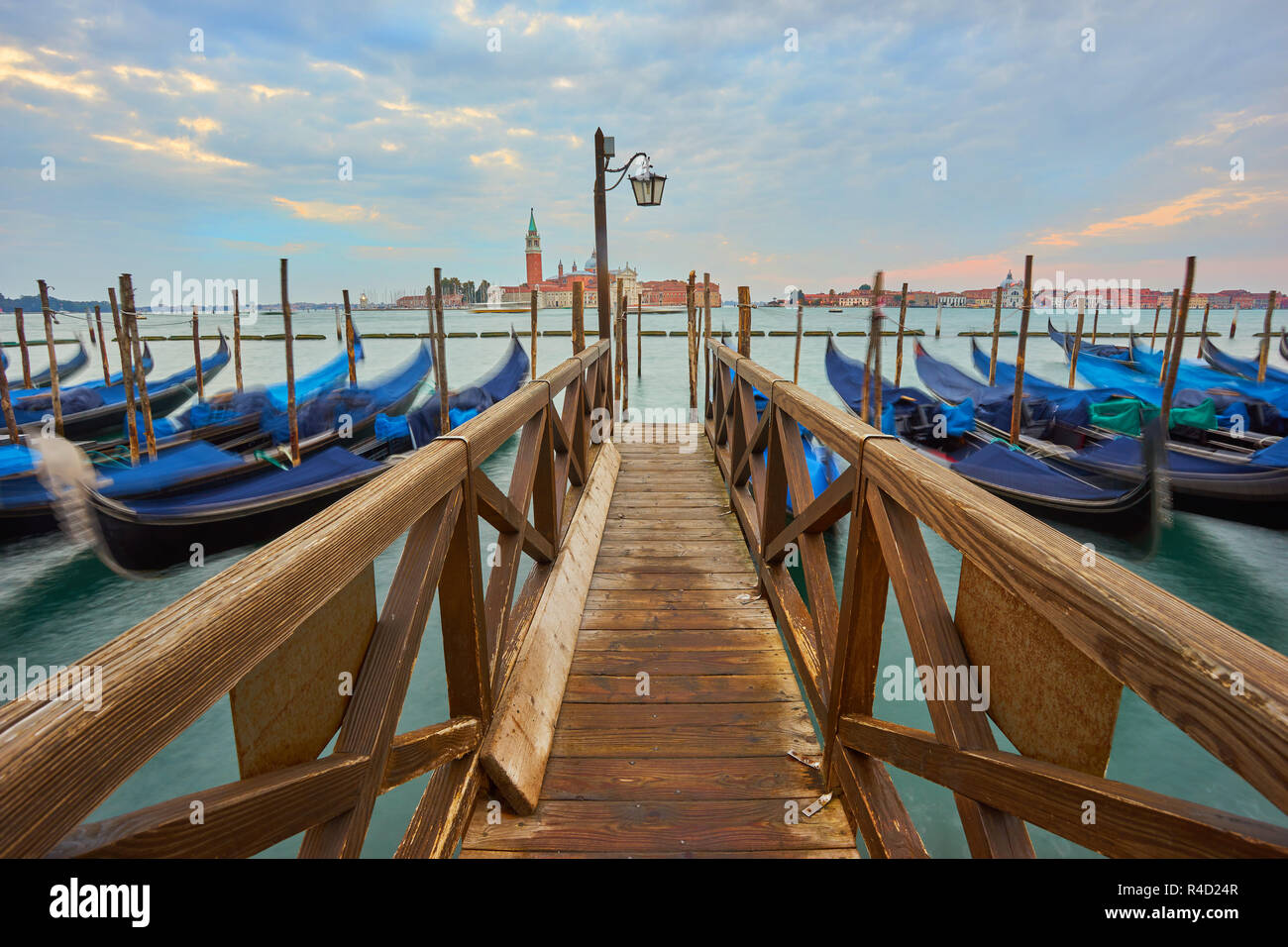 Condolas and wooden pier in Venice, Italy Stock Photo - Alamy