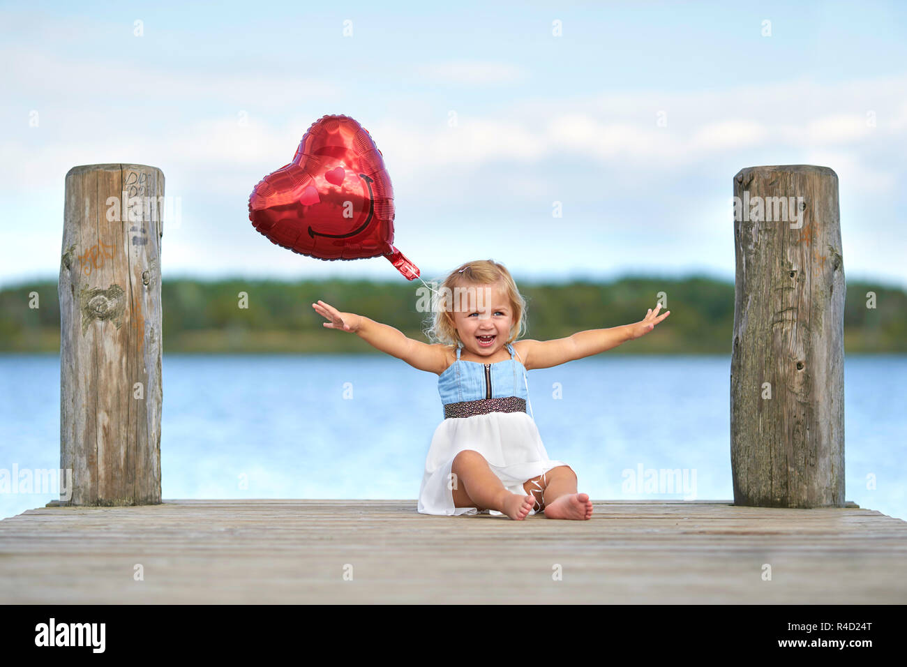Â holidays on the lake,girls with heart balloons Stock Photo