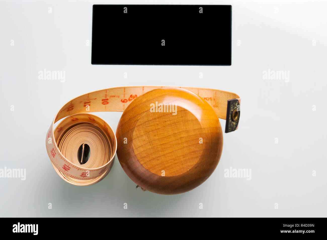 Yoyo effect in diet concept. Wooden yoyo with centimeter measure