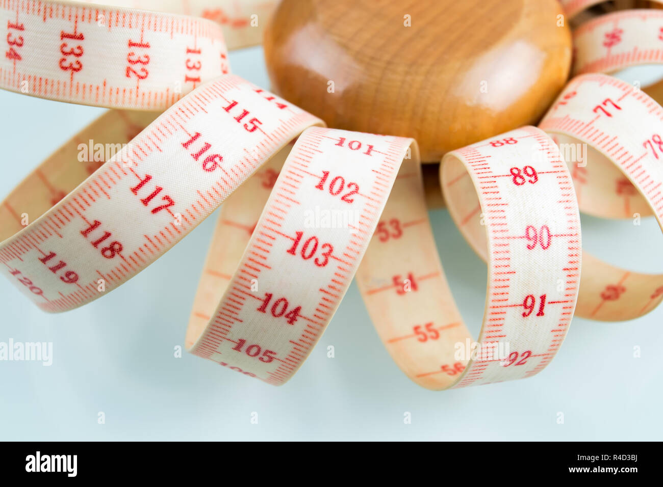 Yoyo effect in diet concept. Wooden yoyo with centimeter measure