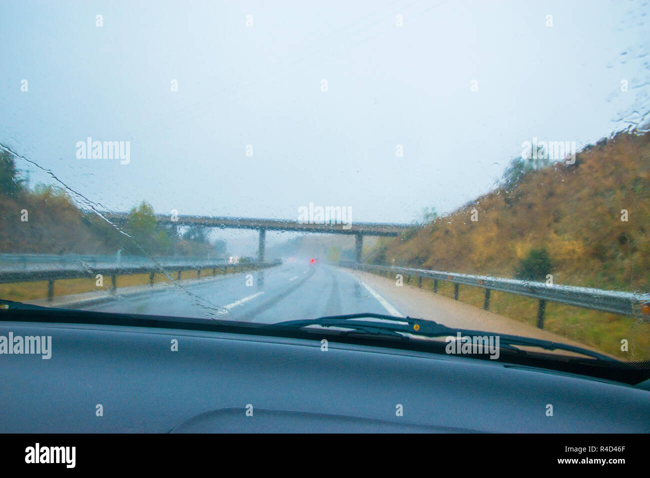 Freeway viewed from inside a car in a rainy day. Stock Photo