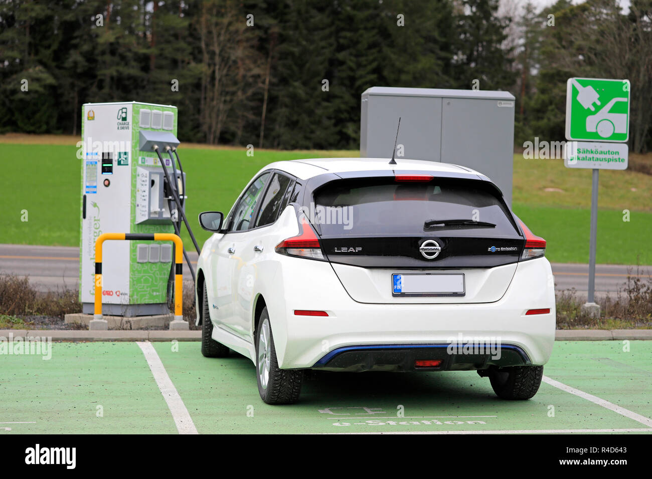 Salo, Finland - November 23, 2018: Nissan Leaf electric car charging battery at Fortum Charge & Drive Fast Charger in South of Finland, rear view. Stock Photo