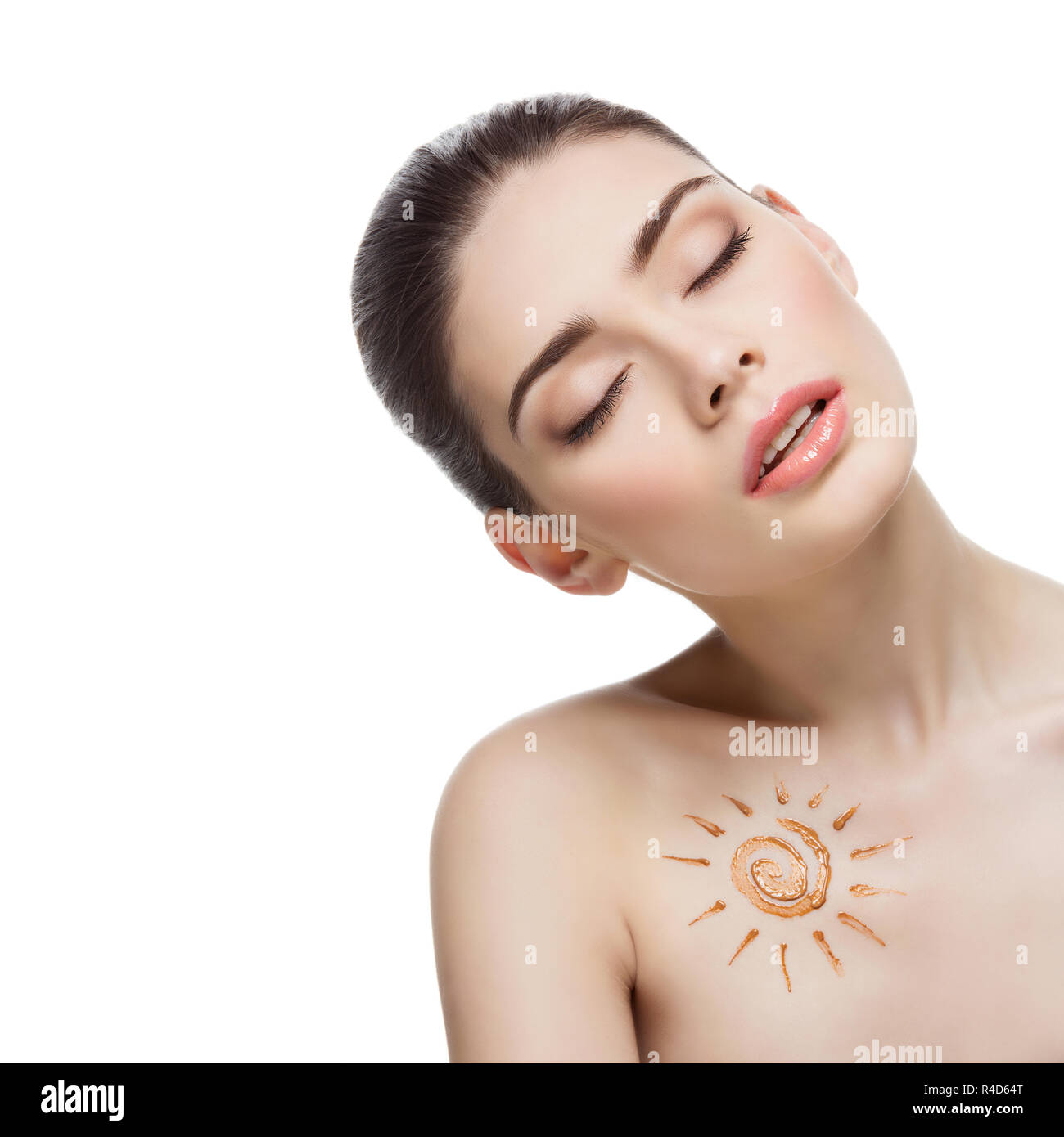 Girl with cream sun shape drawing on chest Stock Photo