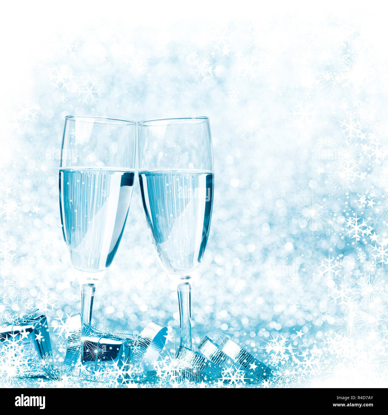 Glasses of champagne and silver gifts on glitter background Stock Photo
