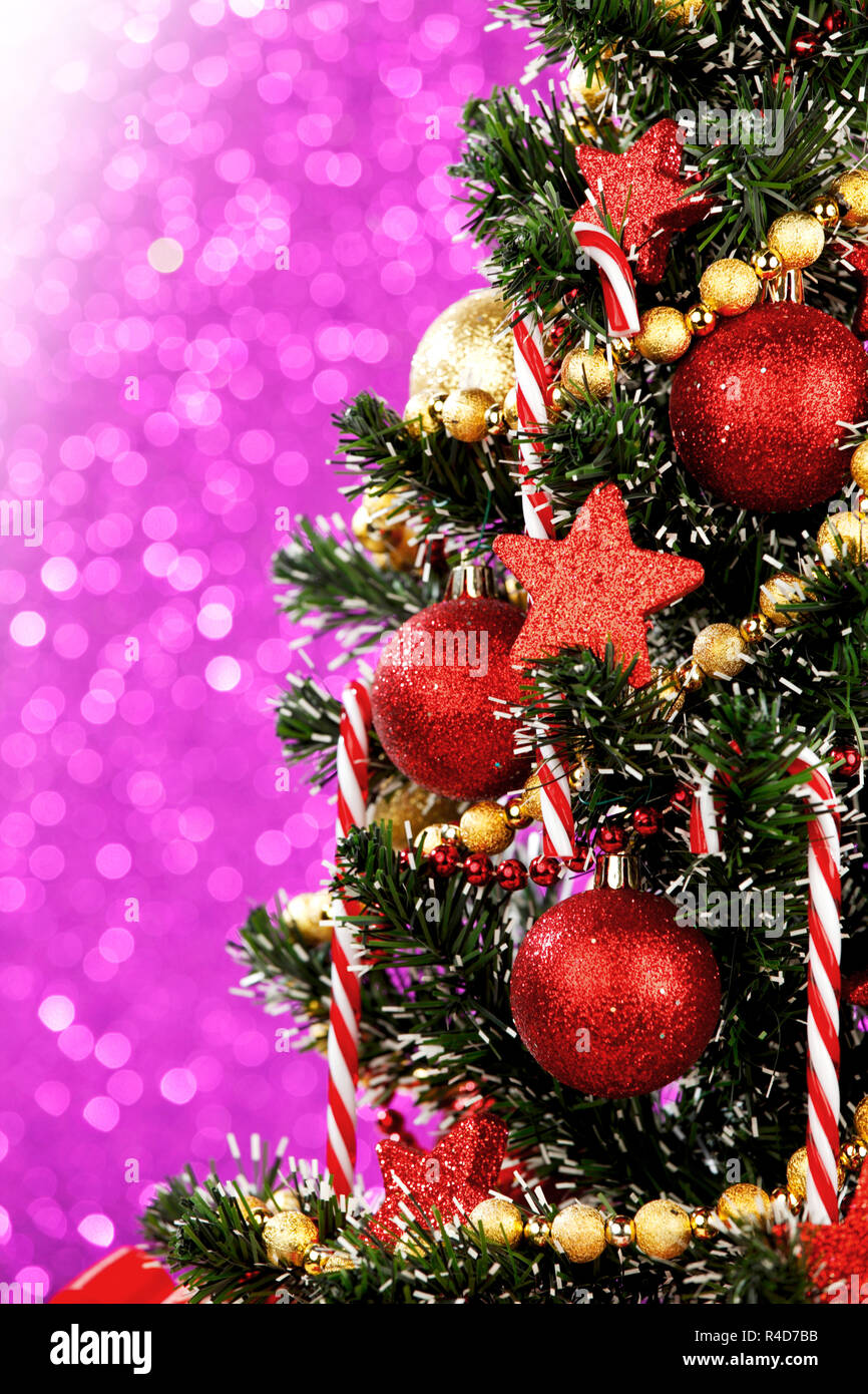 Beautiful decorated christmas tree on glitter purple background Stock ...