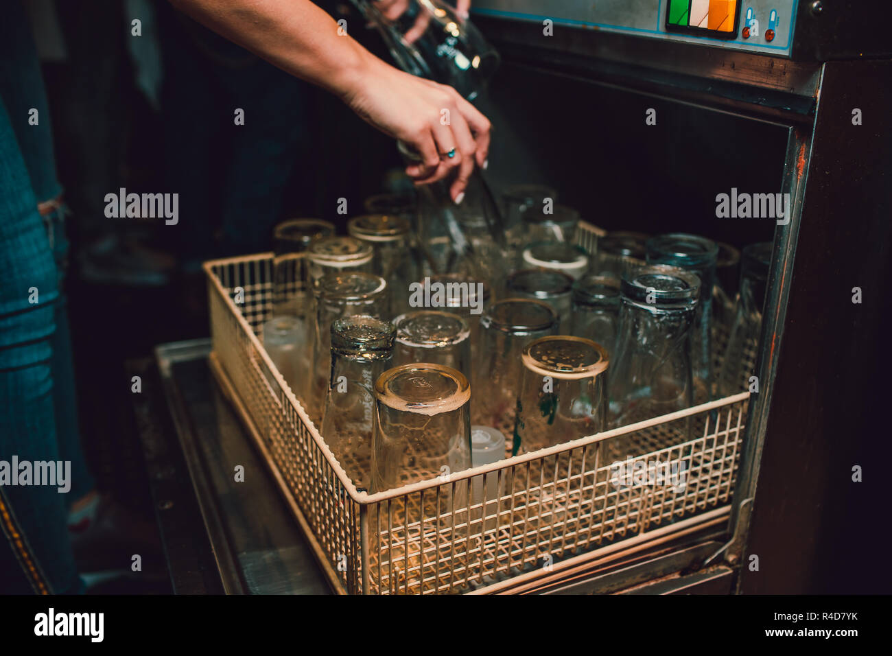 Discharging clean and shiny glasses from the dishwasher Stock Photo Alamy