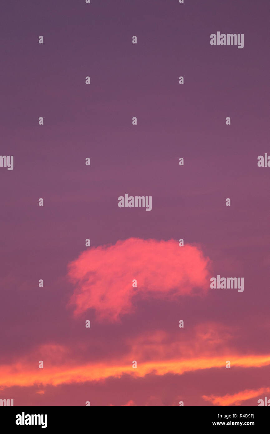 Small pink cloud at sunset sky Stock Photo