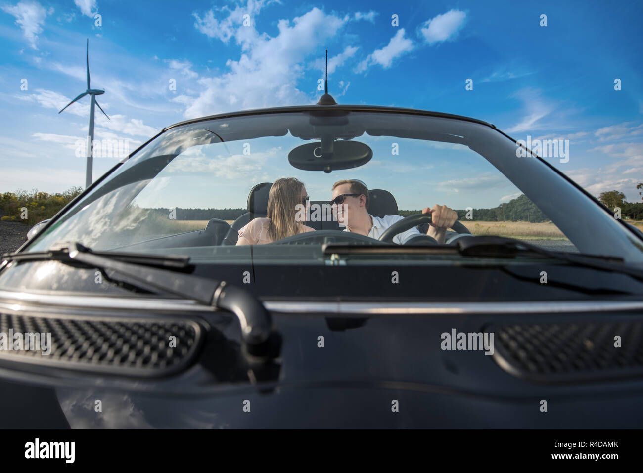 young loving couple in cabriolet is looking at each other Stock Photo