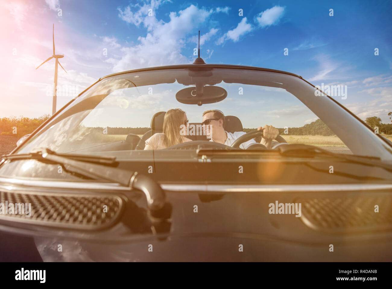 young couple in convertible looks in love Stock Photo