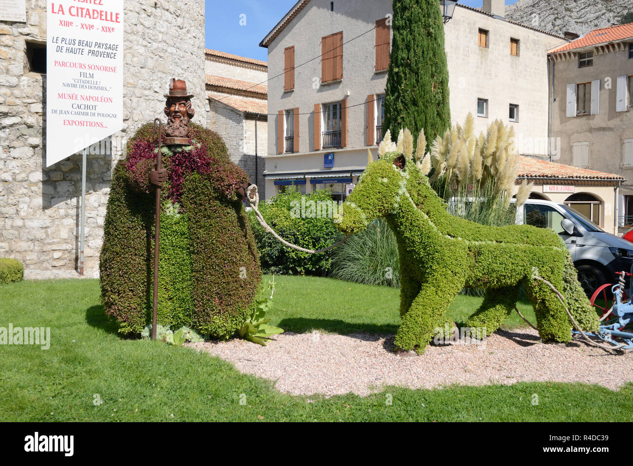 Topiary Sculpture of Provencal Shephard or Farmer and Donkey in Town Square Sisteron Provence France Stock Photo
