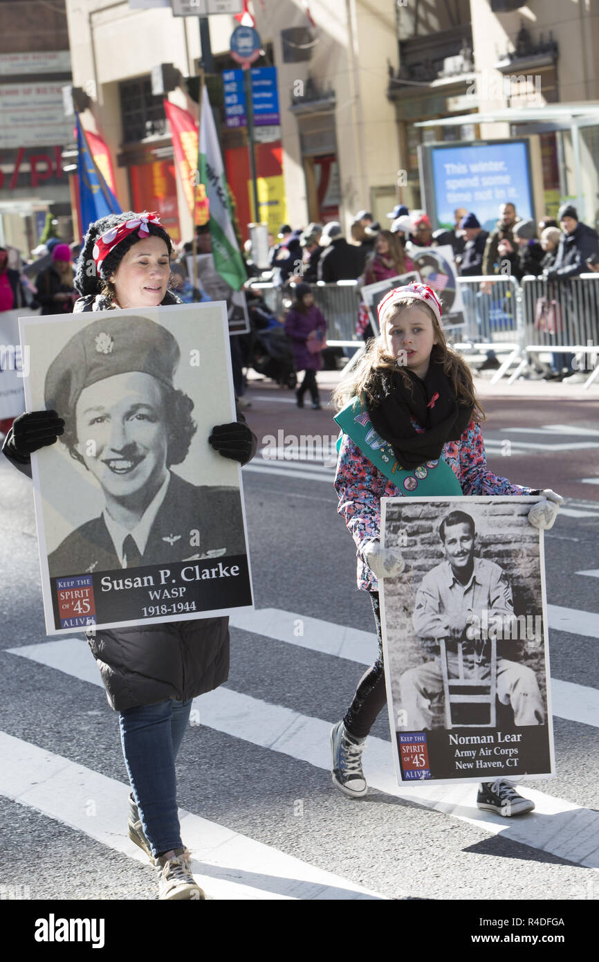 Honoring the Spirit of 1945, kids carry WWll Vet photos who fought and died for the US during the war. Stock Photo