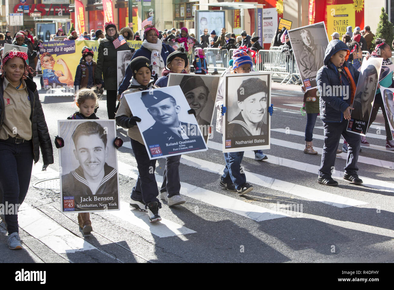 Honoring the Spirit of 1945, kids carry WWll Vet photos who fought and died for the US during the war. Stock Photo