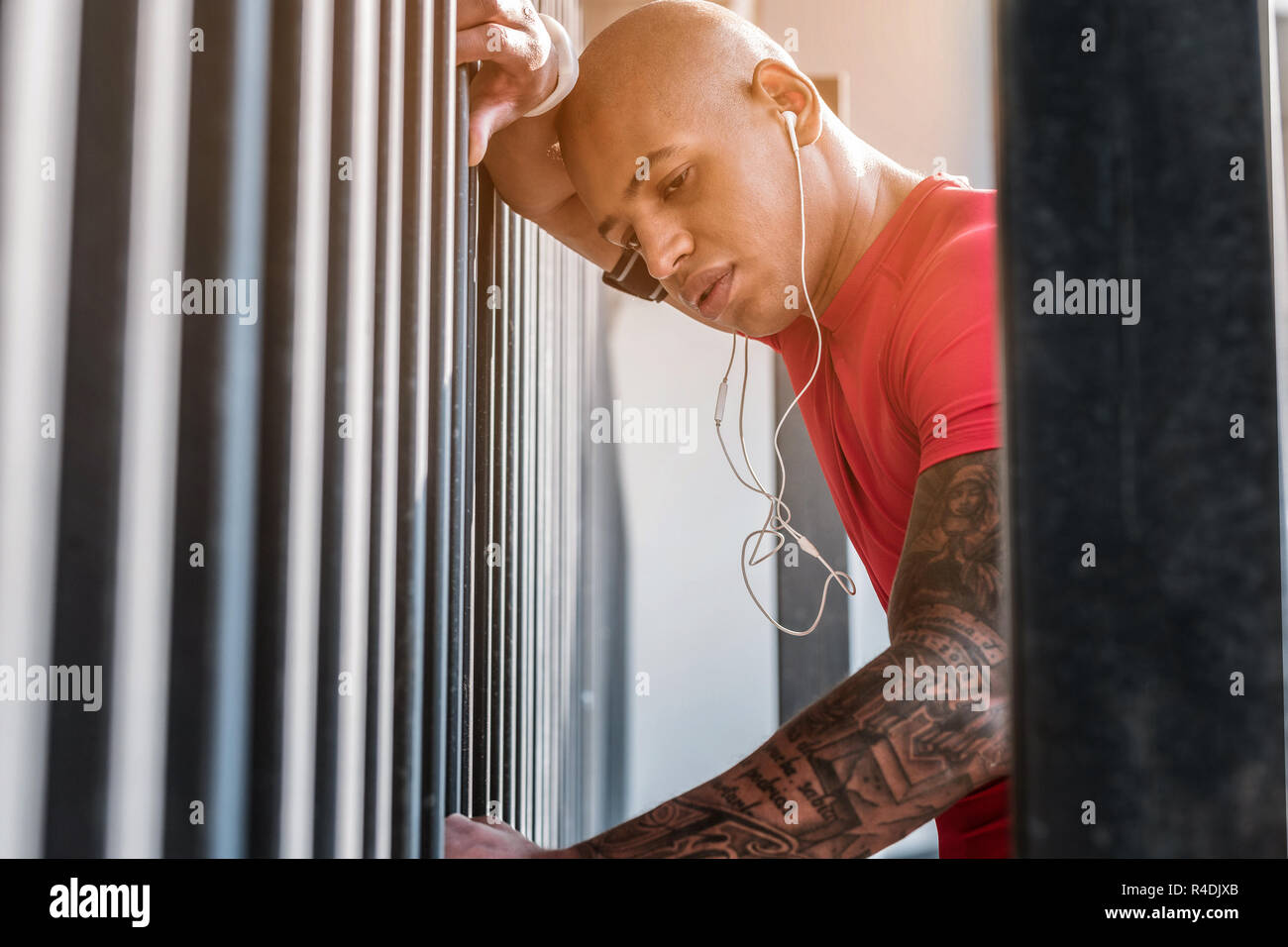Pleasant young man standing neat the wall Stock Photo