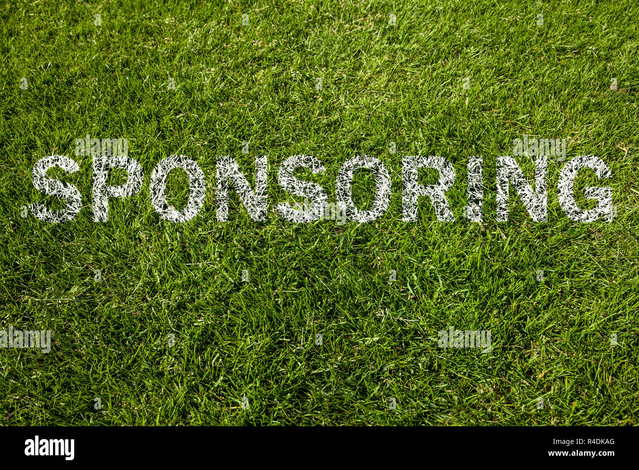 sponsoring text on meadow Stock Photo