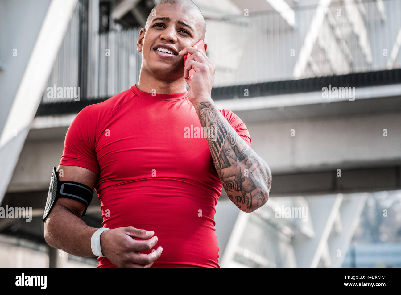 Joyful handsome young sportsman making a call Stock Photo