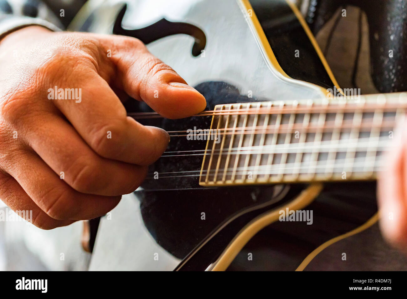 Close up hands of man playing 8string mandolin Stock Photo Alamy