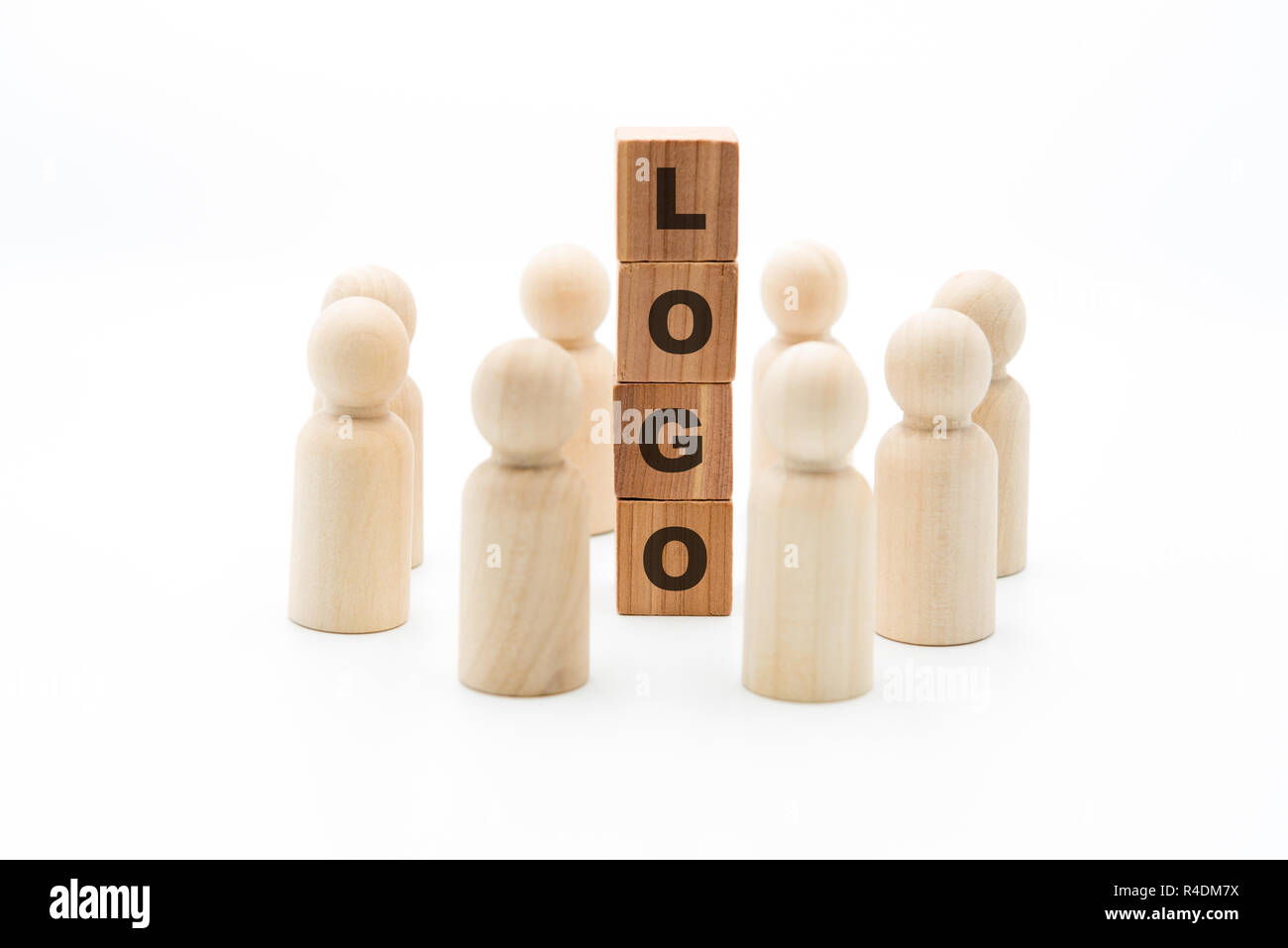 Wooden figures as business team in circle around word LOGO, isolated on white background, minimalist concept Stock Photo