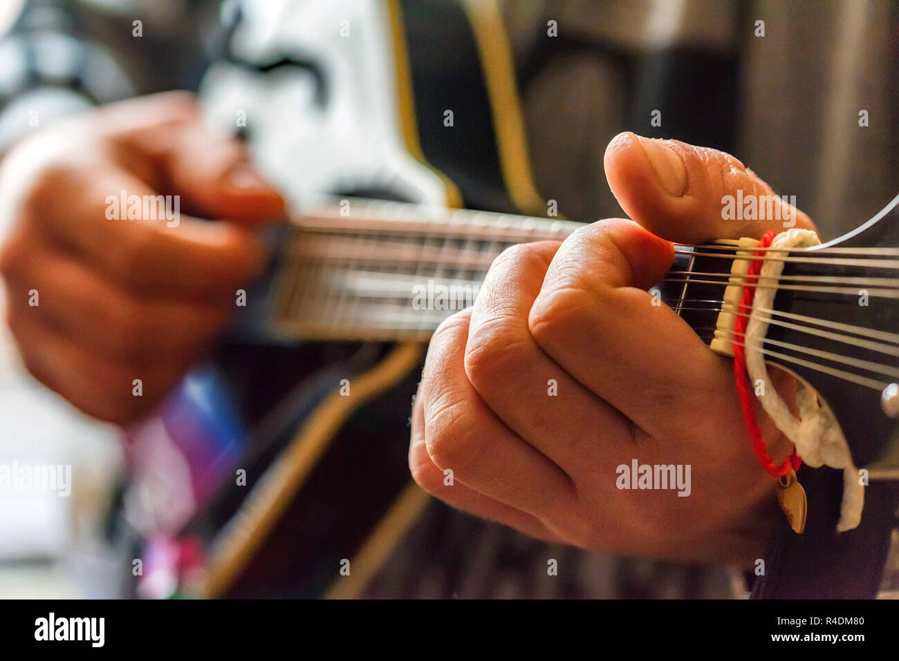 Close up hands of man playing 8string mandolin Stock Photo Alamy