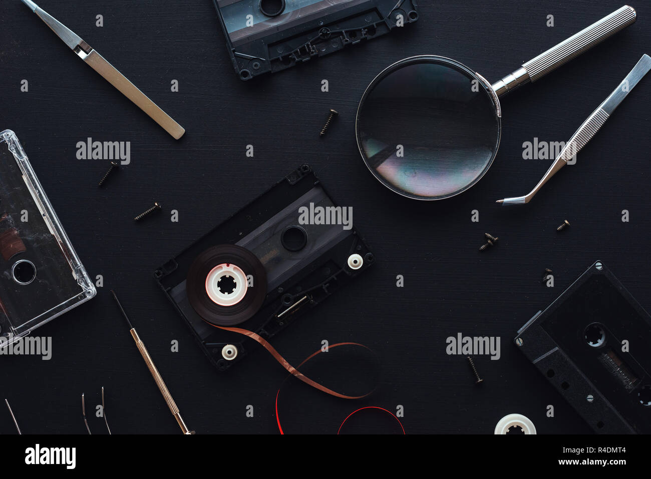 Flat lay audio cassette parts on dark background, top view of retro technology and media concept Stock Photo
