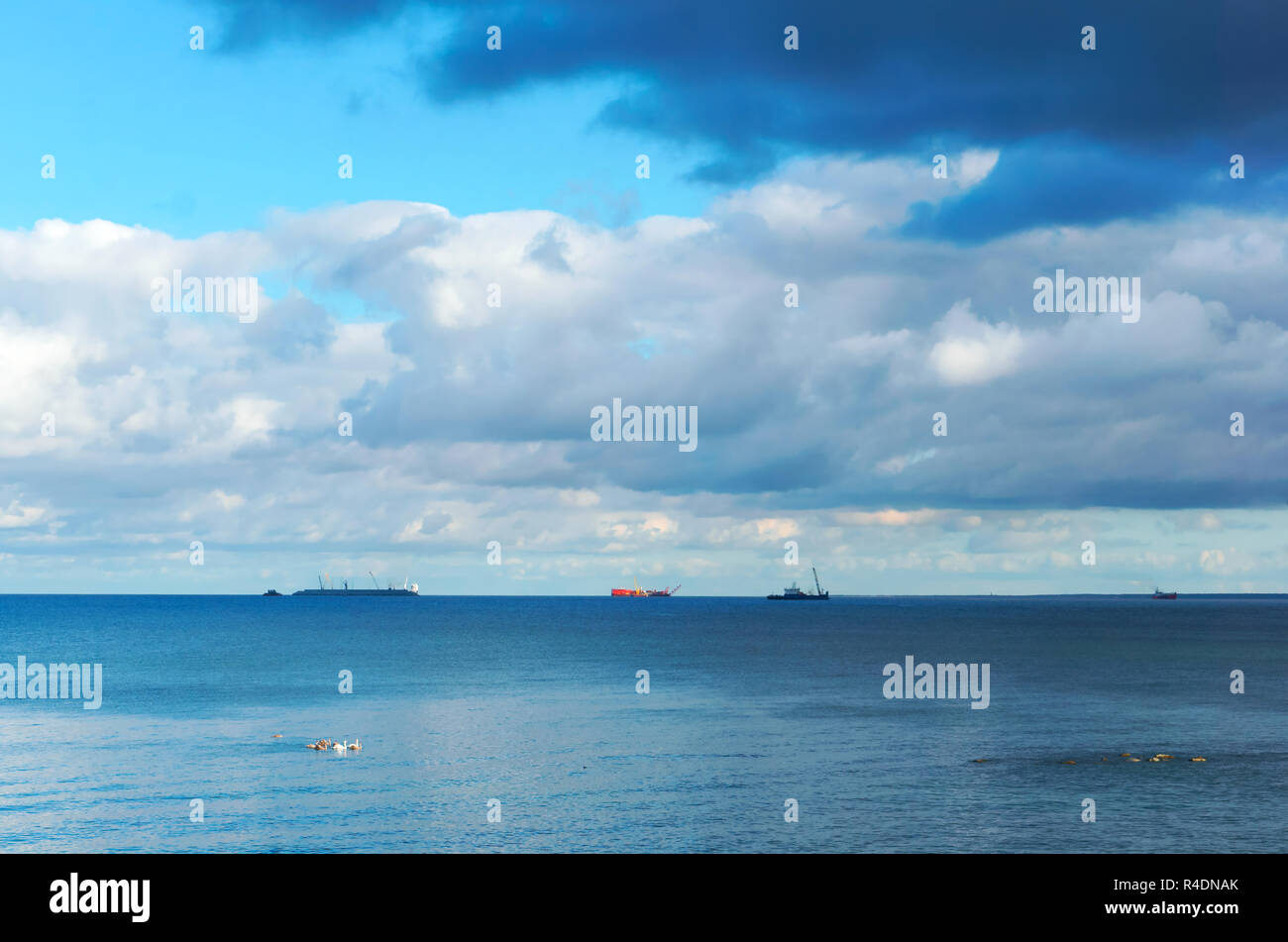 green sea waves, three ships on the horizon, Baltic sea Stock Photo