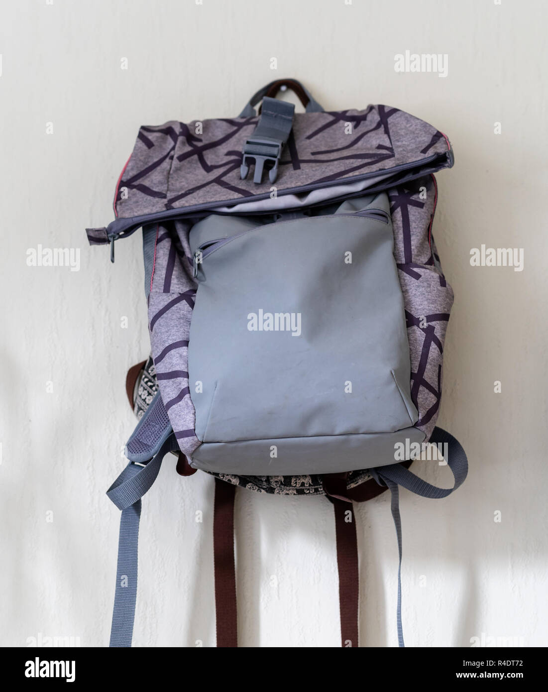 Purple School Backpack Hanging on the Wall - Isolated Object with White Background Stock Photo