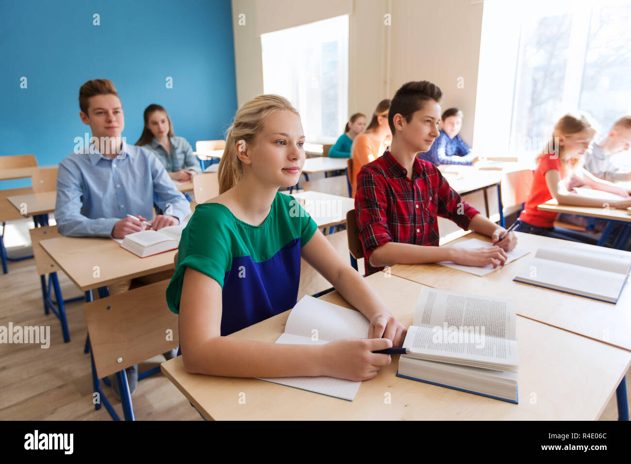 group of students with books at school lesson Stock Photo - Alamy