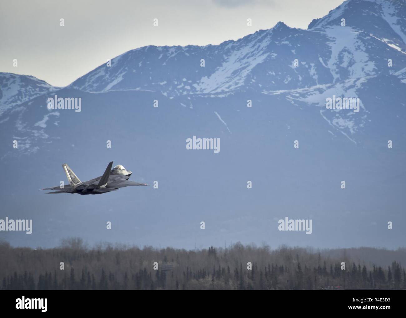 JOINT BASE ELMENDORF-RICHARDSON, Alaska -  An F-22 attached to the 18th Aggressor Squadron from Eielson Air Force Base, Alaska, takes off for a training mission May 1, 2017. Northern Edge 2017 is Alaska's premiere joint-training exercise designed to practice operations, techniques, and procedures as well as enhance interoperability among the services. Thousands of participants from all the services; Airmen, Soldiers, Sailors, Marines, and Coast Guard personnel from active duty, Reserve and National Guard units, are involved. Stock Photo