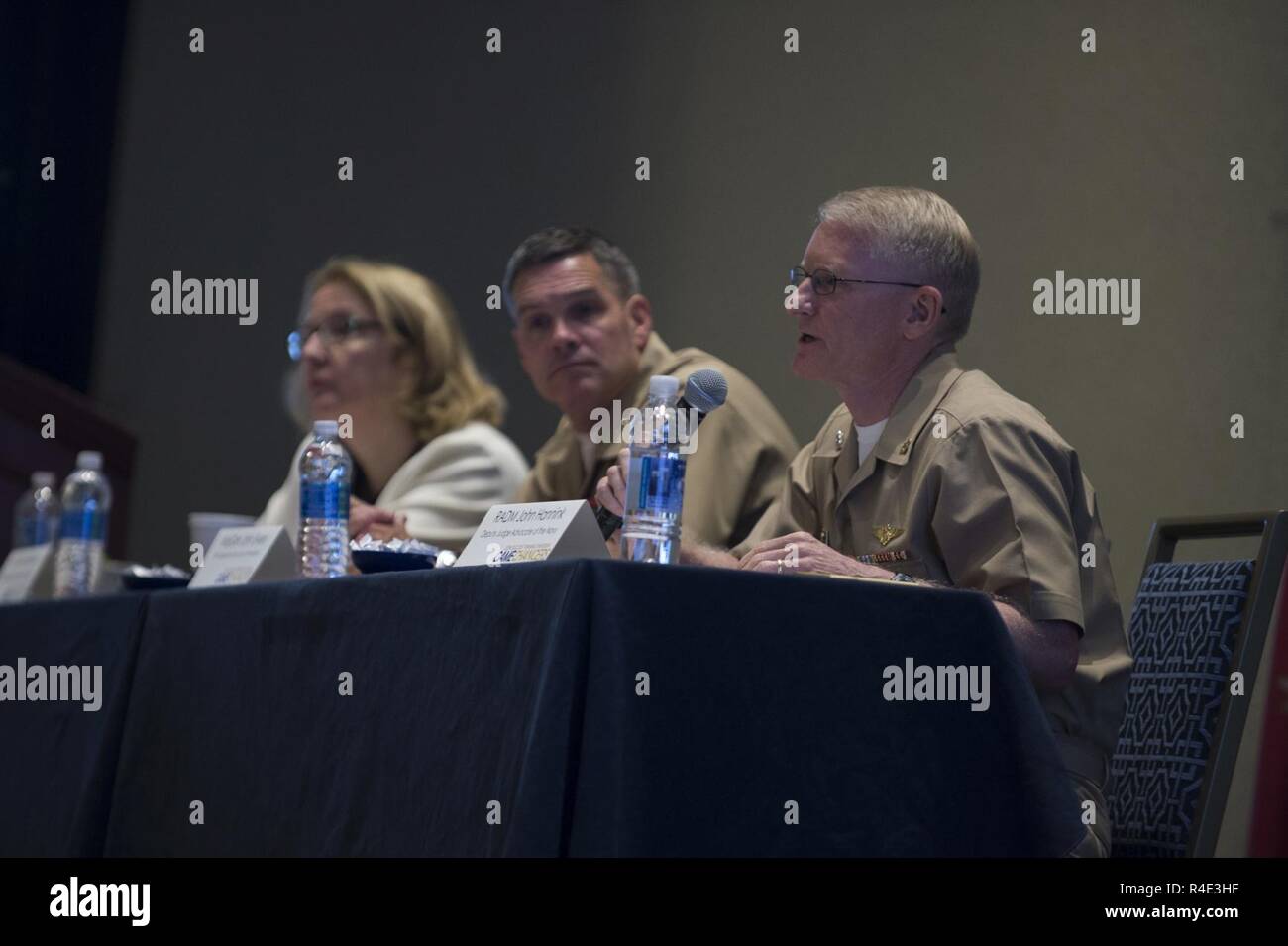 NATIONAL HARBOR, Md. (May. 1, 2017) Rear Adm. John Hannink, right, Deputy Judge Advocate General, is joined by Ms. Anne Brennan, Acting General Counsel of the Navy, left, and Maj. Gen. John Ewers, Staff Judge Advocate to the Commandant, for a Department of the Navy (DON) legal advisors panel during the DON Office of the General Counsel 2017 annual training symposium. Stock Photo