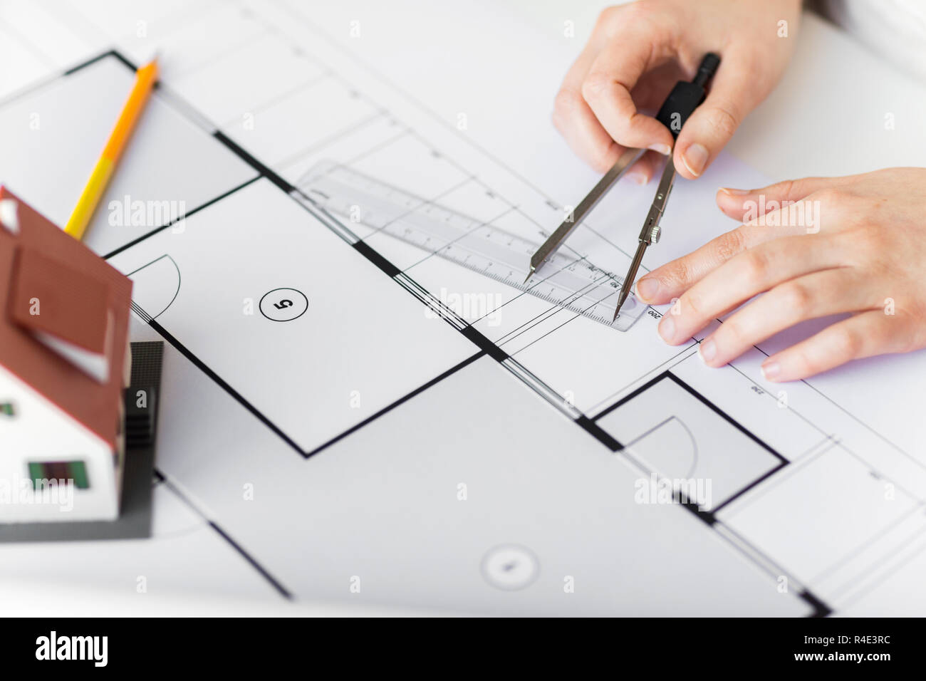 close up of hands with compass measuring blueprint Stock Photo Alamy