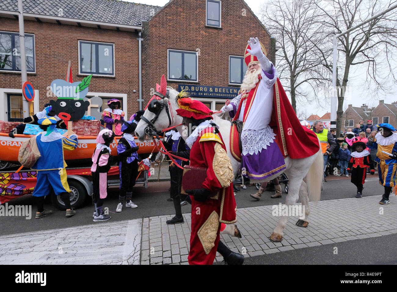 Graveren Effectief Beheer Sinterklaas (St. Nicholas), accompanied by people dressed as traditional  characters known as Zwarte Piet or Black Pete, ride a horse as children  wave during a parade November 24, 2018, in Katwijk, Netherlands.