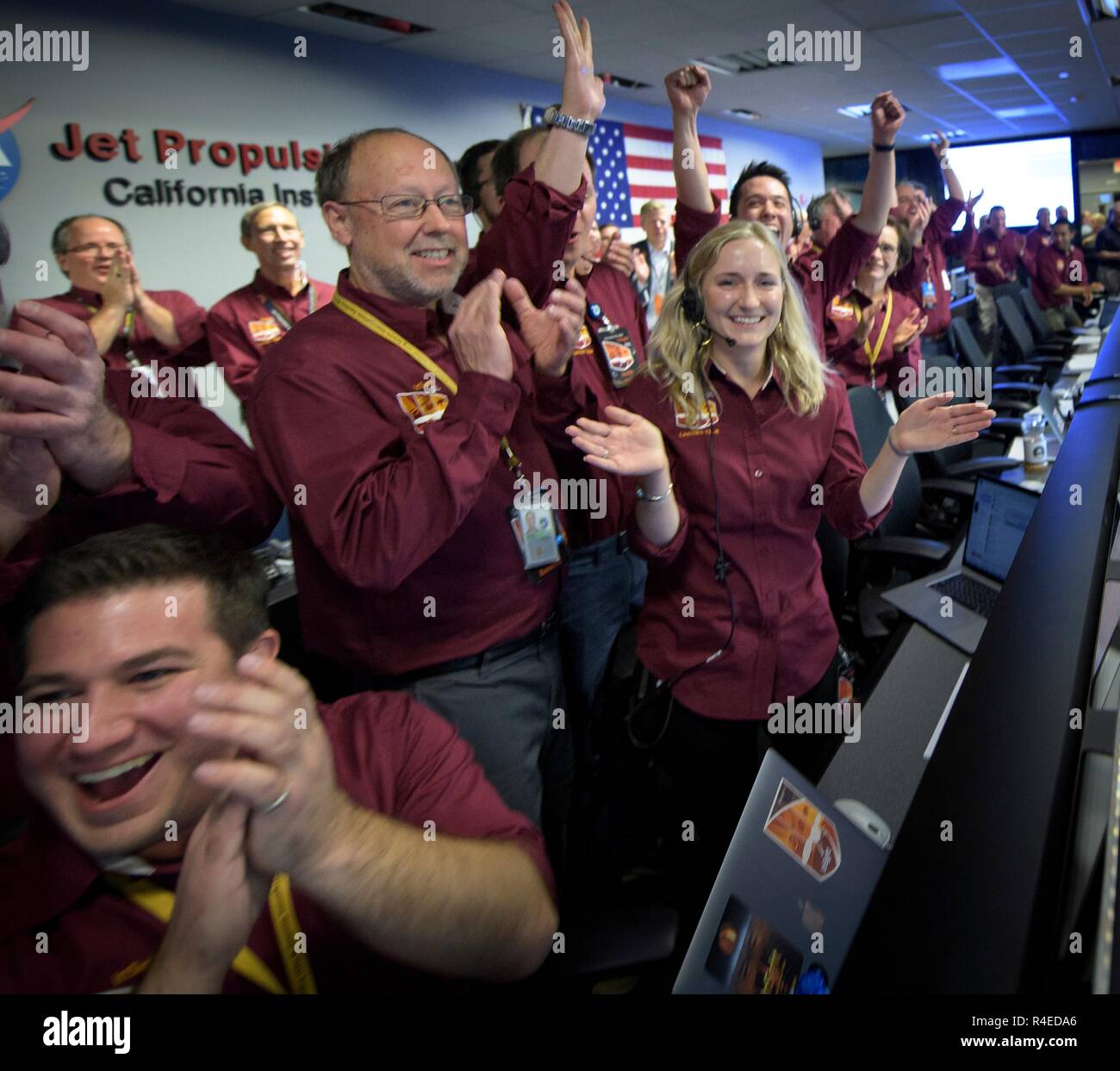 Bruce Banerdt, InSight Principal Investigator, left, Hallie Gengl, Data Visualization Developer, and other team members react after receiving confirmation that the Mars InSight lander successfully touched down on the surface of Mars November 26, 2018 inside the Mission Support Area of the Jet Propulsion Laboratory in Pasadena, California. InSight, short for Interior Exploration using Seismic Investigations, Geodesy and Heat Transport, is a Mars lander designed to study the inner space of Mars. Stock Photo
