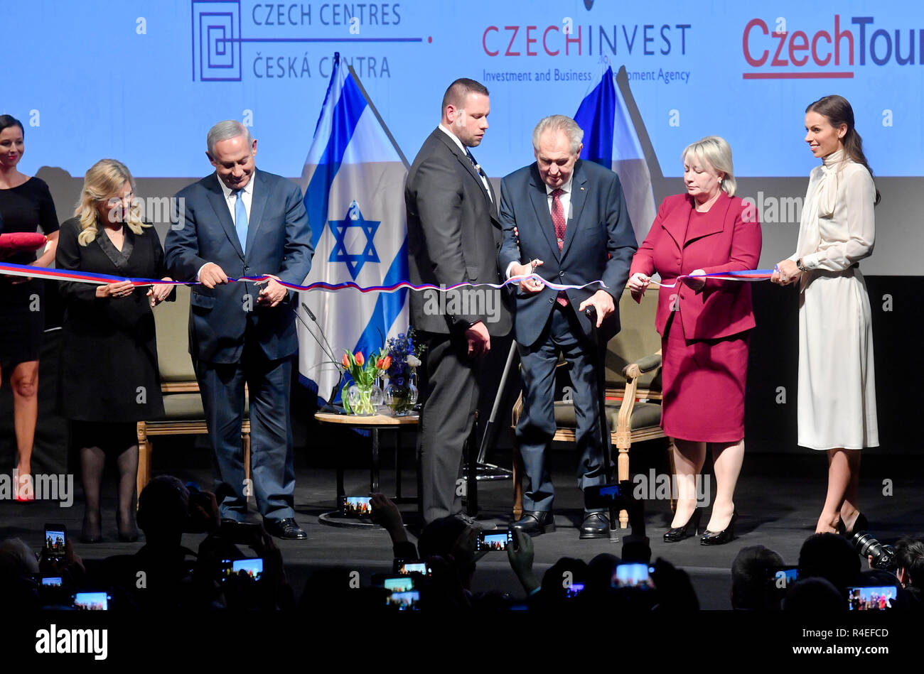 Israeli Prime Minister Benjamin Netanyahu and his wife Sara Netanyahu (left) and Czech President Milos Zeman and his wife Ivana Zemanova opened the Czech House in Jerusalem, Israel, today on November 27, 2018. The Czech House, a joint office of state agencies CzechTrade, CzechInvest, CzechTourism and Czech Centers, is situated in the building of Cinematheque near the Old Town in Jerusalem. Zeman said he believes his next visit will be on the occasion of opening of the Czech embassy in Jerusalem. A man standing at centre is bodyguard supporting Czech President. (CTK Photo/Vit Simanek) Stock Photo