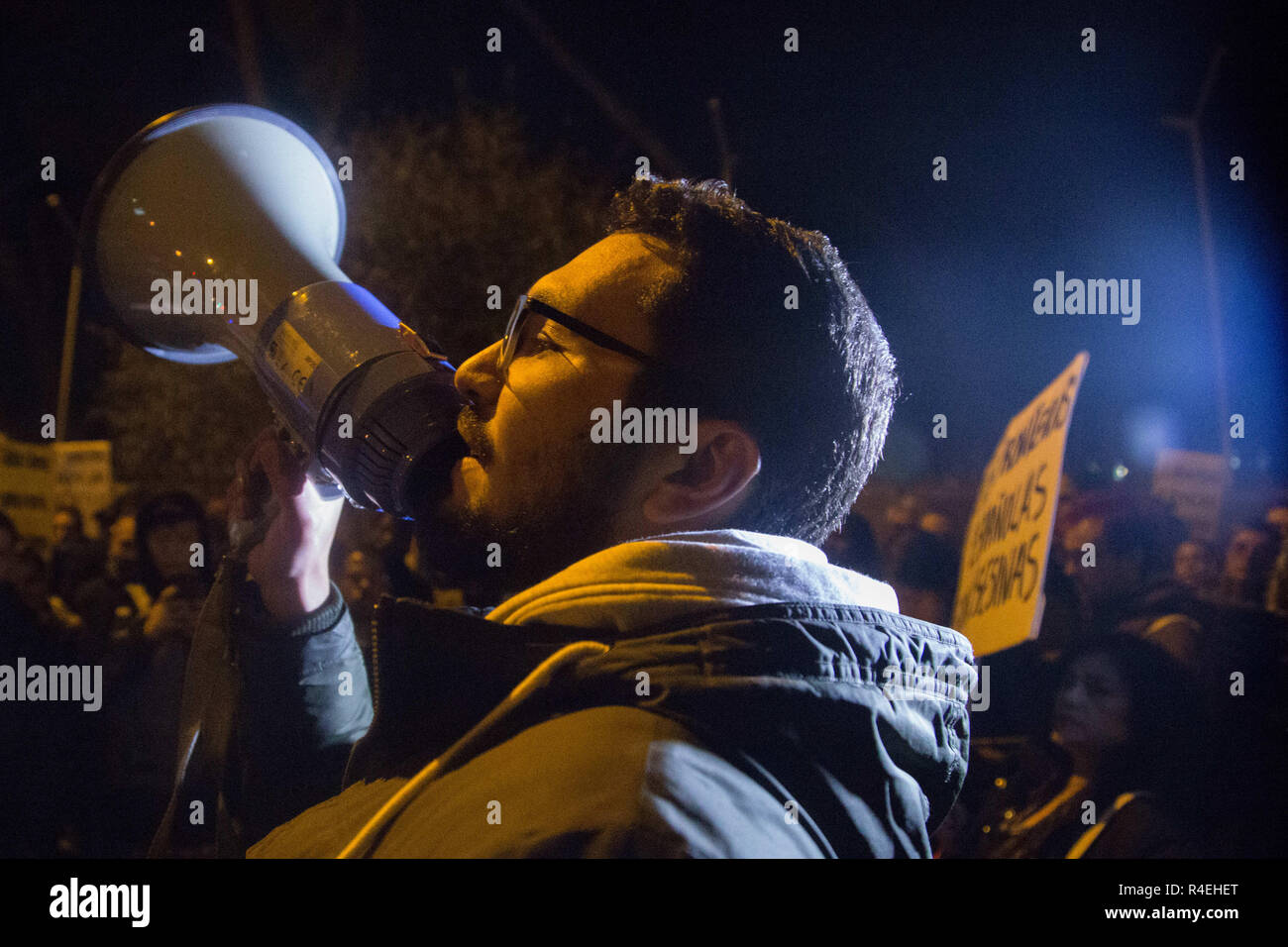 Madrid, Spain. 27th Nov, 2018. A protester seen shouting for the closure of the Immigration Detention Centres on a megaphone during the protest.Demonstration was held in front of the Immigration Detention Centre to demand for the closure of this centre and the rest in Europe for treating undocumented immigrants as criminals, depriving them of freedom, against Human Rights and for the racist treatment in them. Credit: Lito Lizana/SOPA Images/ZUMA Wire/Alamy Live News Stock Photo