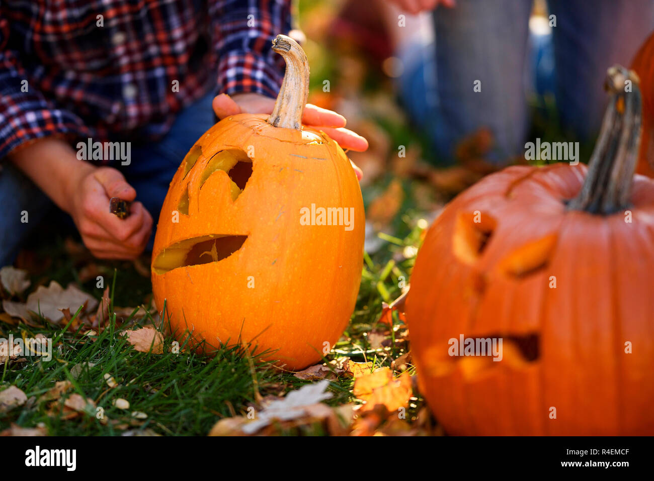 Brother And Sister Sitting In The Garden Carving Halloween Pumpkins United States Stock Photo Alamy