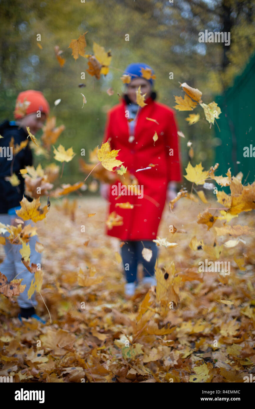 Woman walking in the park with her son in autumn, Russia Stock Photo