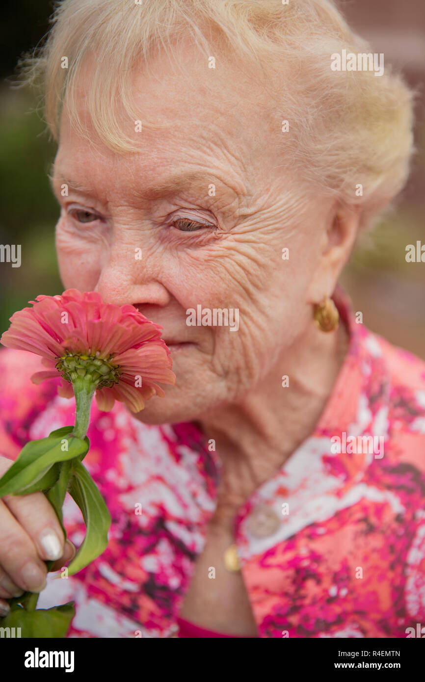 Close Up Of Woman Smelling Flowers Stock Photo